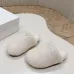 Prada Women’s White Sheepskin Slippers – Fuzzy Mules with Gold Triangle Logo Tab, Soft Indoor Footwear #A69834